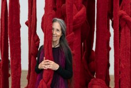 Portrait of Cecilia Vicuña in front of Quipu Womb 2017.